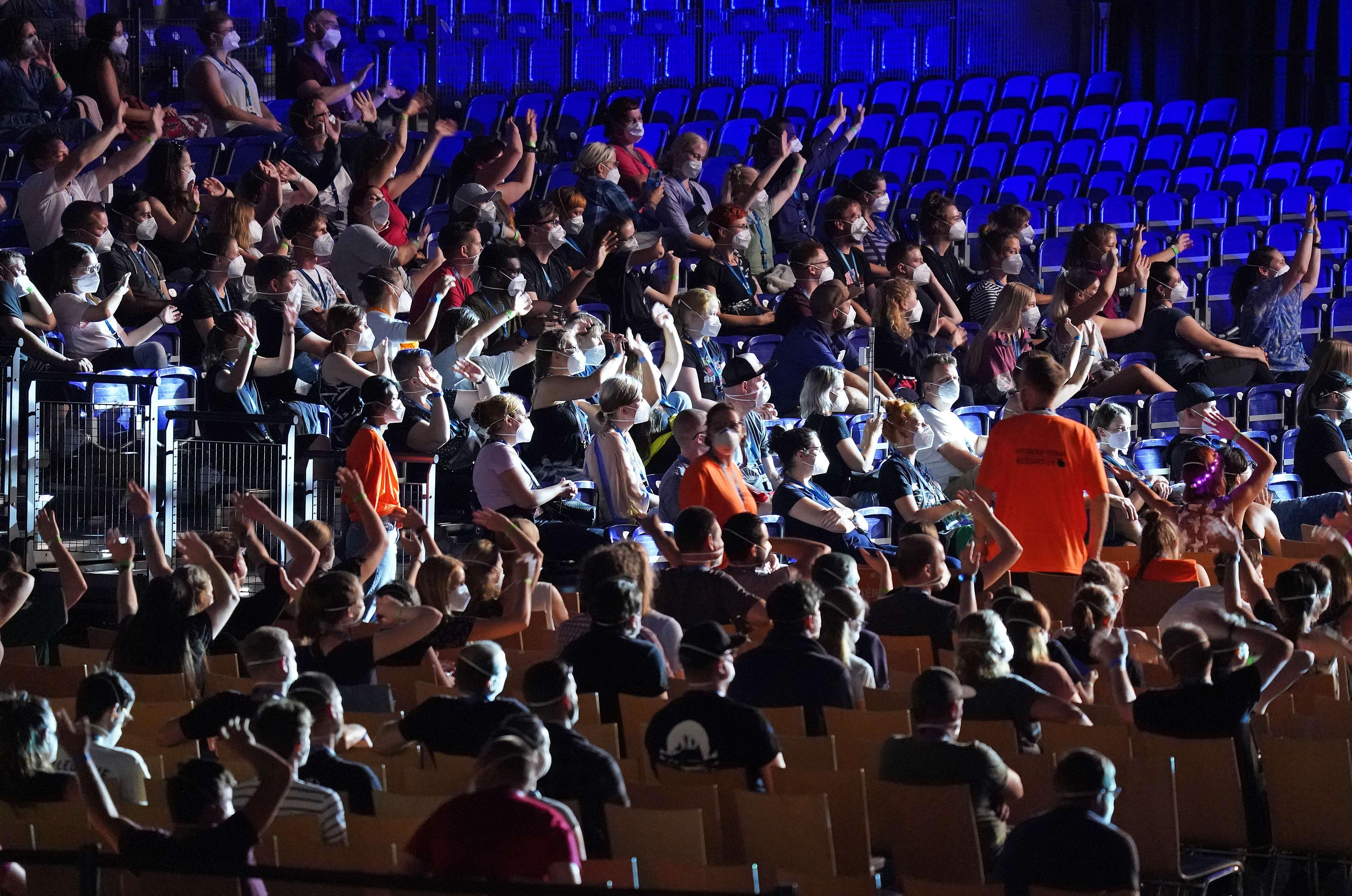 Participants wearing face masks watch singer Tim Bendzko perform in the RESTART-19 Covid transmission risk assessment study in a concert setting at an indoor arena during the coronavirus pandemic on Aug. 22, 2020 in Leipzig, Germany. 
