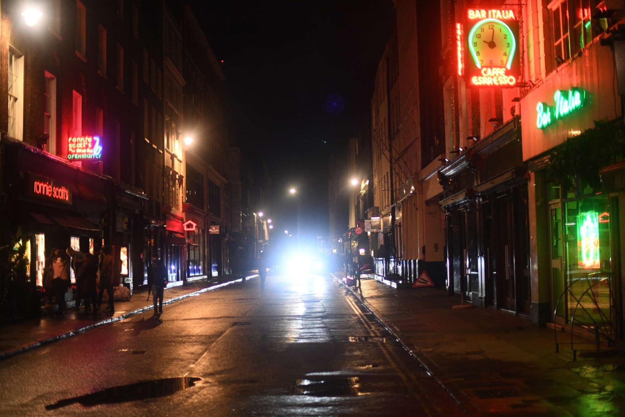People make their way home from Soho, London, following the 10 p.m. curfew imposed on the country.