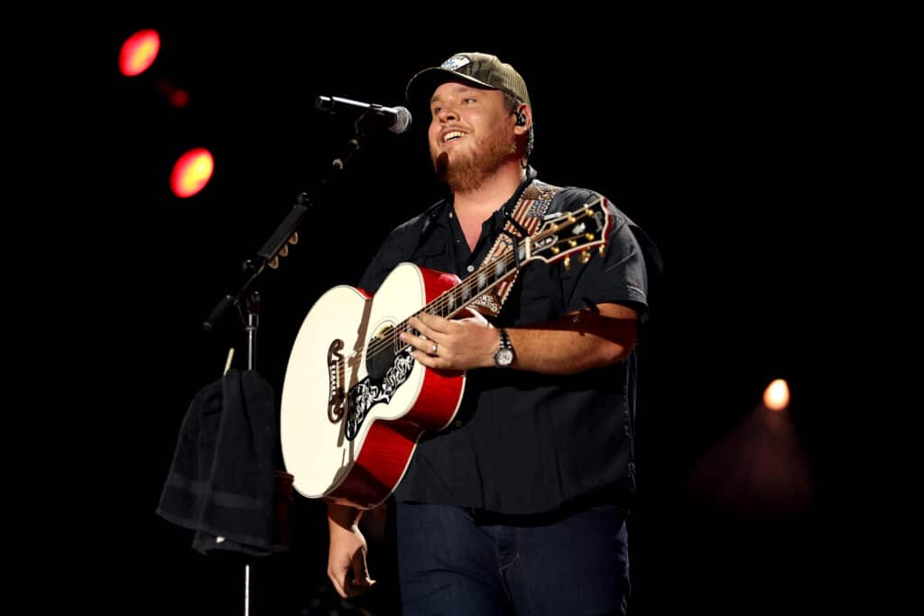 Luke Combs stands with his guitar while performing at day three of CMA Fest 2022 at Nissan Stadium on June 11, 2022 in Nashville, Tennesse. 